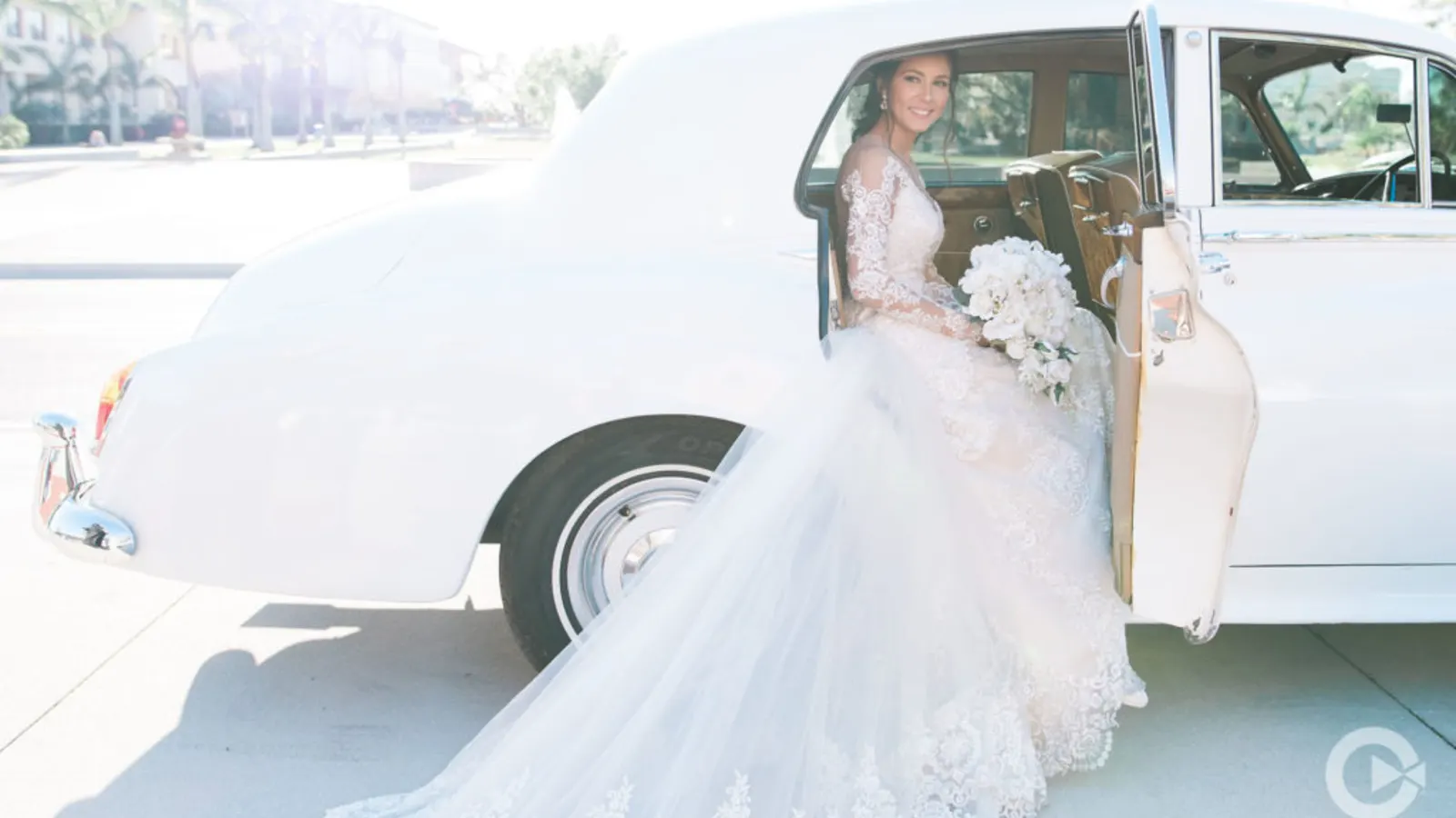 A bride stepping into a chauffeured luxury wedding car at a Dallas-Fort Worth venue.